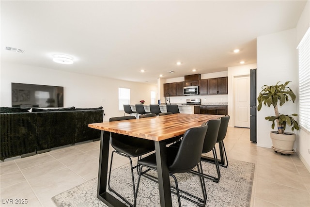 dining room featuring recessed lighting, light tile patterned floors, and visible vents