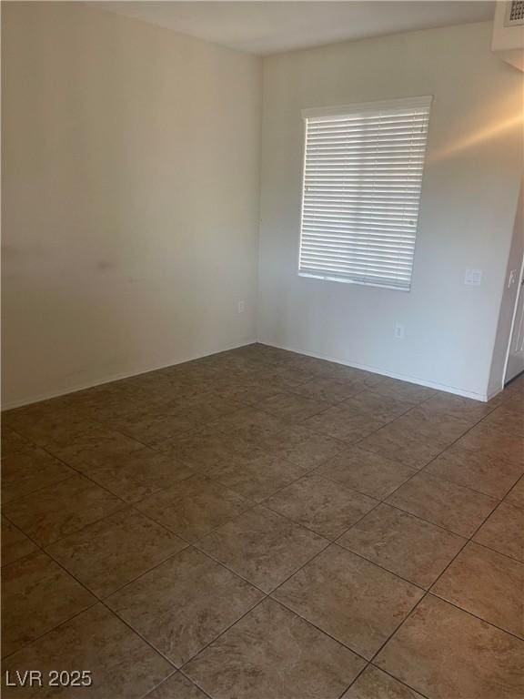 spare room featuring tile patterned flooring