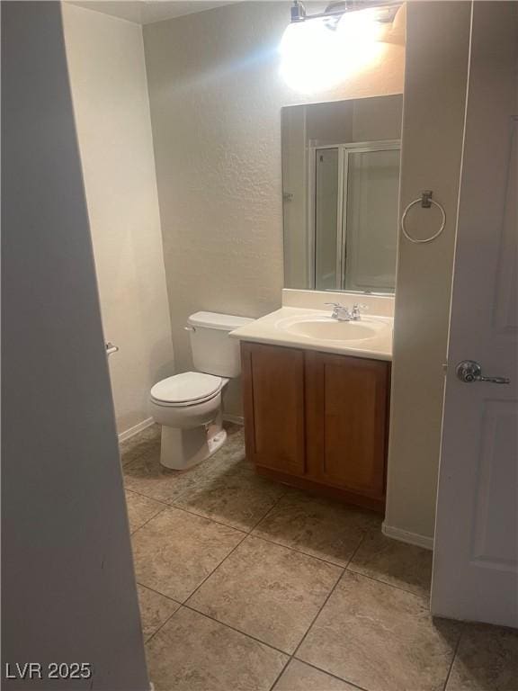 full bath featuring a shower stall, toilet, tile patterned flooring, and vanity