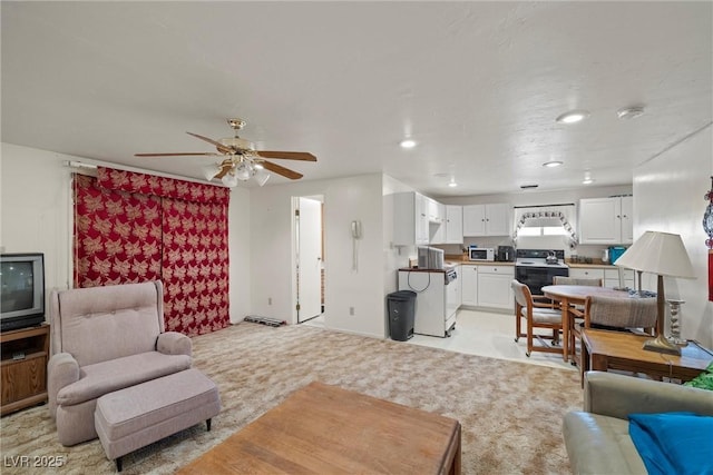 living area featuring recessed lighting, light carpet, and ceiling fan