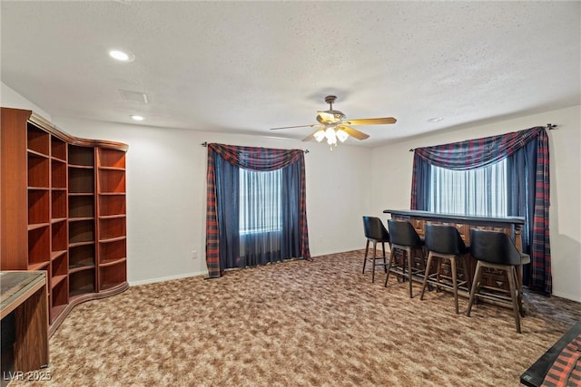carpeted dining area with a textured ceiling, recessed lighting, a ceiling fan, and plenty of natural light