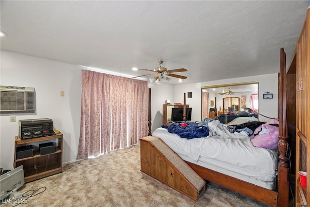 carpeted bedroom featuring a wall mounted air conditioner, ceiling fan, and recessed lighting
