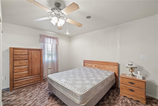 bedroom with dark colored carpet and ceiling fan