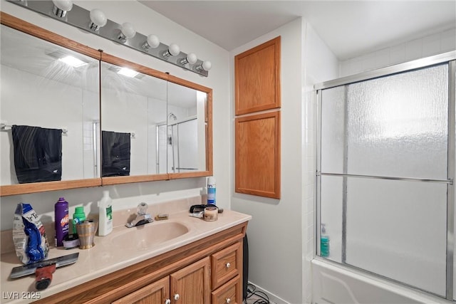 full bath featuring bath / shower combo with glass door and vanity