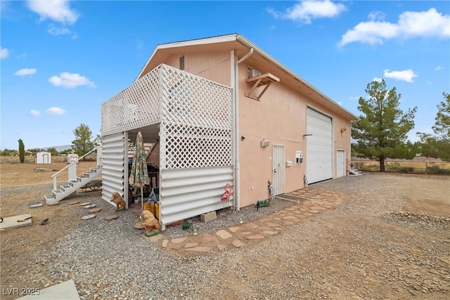 view of side of home featuring an outbuilding