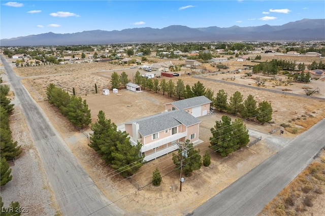 birds eye view of property featuring a mountain view and a rural view