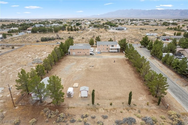 birds eye view of property featuring view of desert and a mountain view