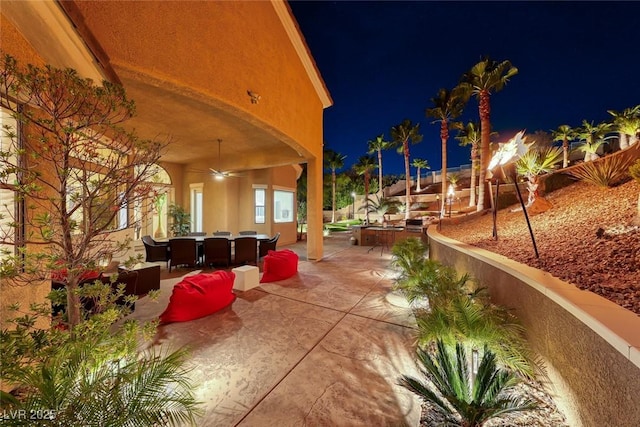2064 Poetry Ave, Henderson, NV 89052 - patio at twilight featuring a ceiling fan and outdoor dining space