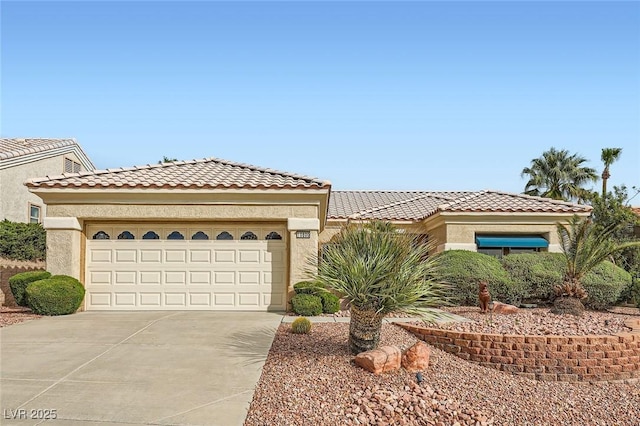 mediterranean / spanish-style house featuring an attached garage, stucco siding, concrete driveway, and a tiled roof