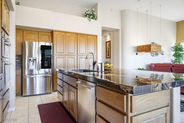 10524 Longwood Dr, Las Vegas, NV 89134 - kitchen featuring light tile patterned flooring, a sink, backsplash, appliances with stainless steel finishes, and dark stone counters