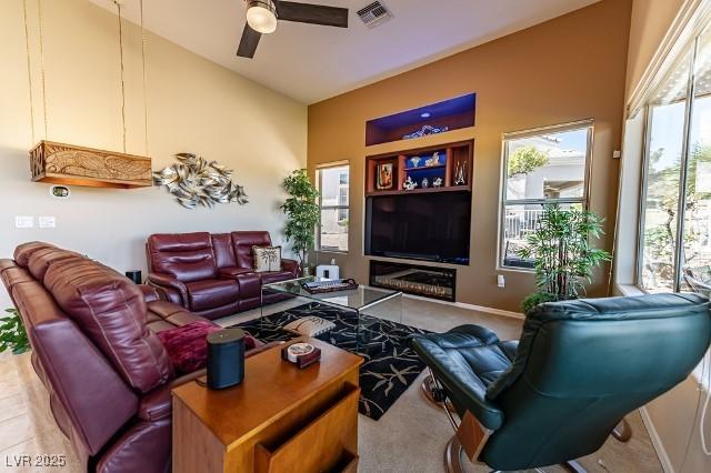 10524 Longwood Dr, Las Vegas, NV 89134 - living area featuring baseboards, visible vents, high vaulted ceiling, and ceiling fan