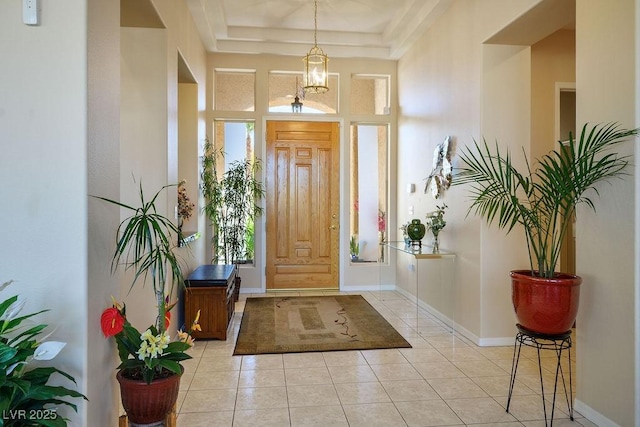 10524 Longwood Dr, Las Vegas, NV 89134 - foyer entrance featuring a tray ceiling, baseboards, and light tile patterned floors