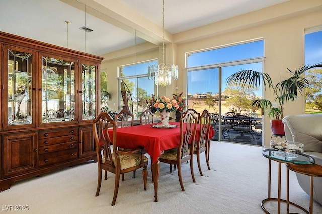 10524 Longwood Dr, Las Vegas, NV 89134 - dining area with light carpet, a notable chandelier, visible vents, and beam ceiling