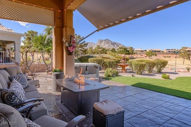 10524 Longwood Dr, Las Vegas, NV 89134 - view of patio / terrace featuring a mountain view, an outdoor living space with a fire pit, and fence