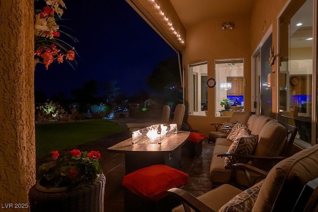 10524 Longwood Dr, Las Vegas, NV 89134 - balcony at twilight with an outdoor living space with a fire pit and a patio area