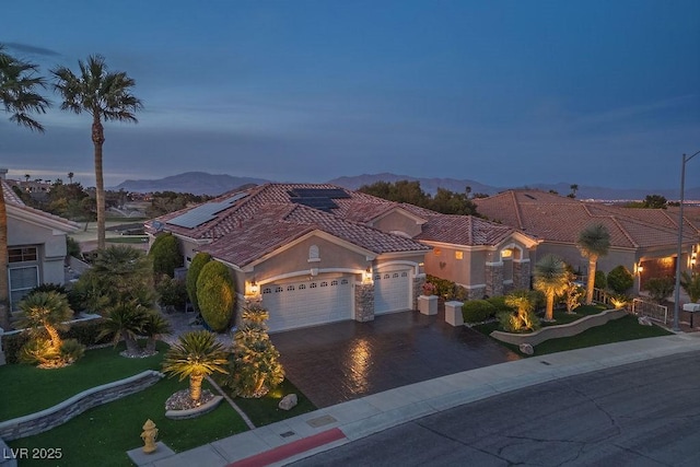 10524 Longwood Dr, Las Vegas, NV 89134 - mediterranean / spanish home with a garage, stucco siding, a tile roof, driveway, and a mountain view