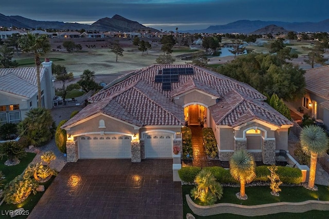 10524 Longwood Dr, Las Vegas, NV 89134 - mediterranean / spanish home featuring stucco siding, an attached garage, and a mountain view