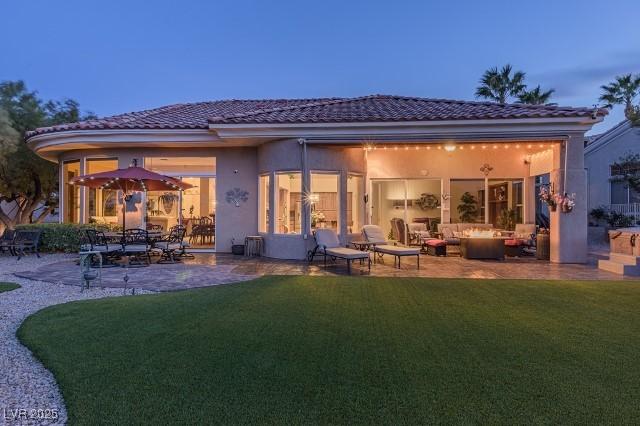 10524 Longwood Dr, Las Vegas, NV 89134 - rear view of house with a tiled roof, stucco siding, a yard, and a patio