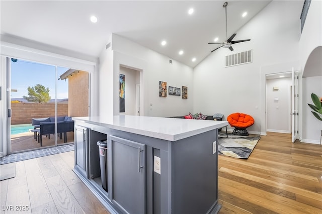kitchen featuring light countertops, visible vents, ceiling fan, light wood-style floors, and a center island