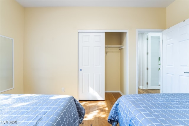 bedroom featuring a closet and wood finished floors