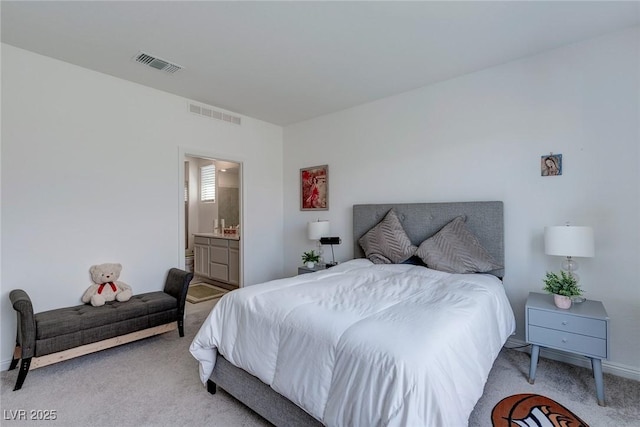 2114 Cold Canyon Ave, North Las Vegas, NV 89086 - bedroom with light colored carpet, visible vents, and ensuite bath