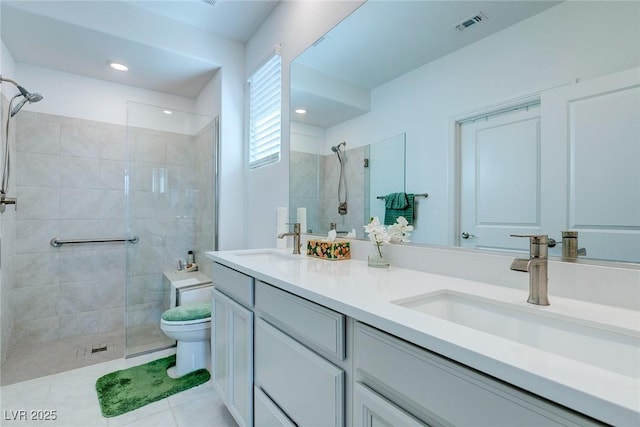 2114 Cold Canyon Ave, North Las Vegas, NV 89086 - full bathroom featuring toilet, a sink, a shower stall, visible vents, and double vanity