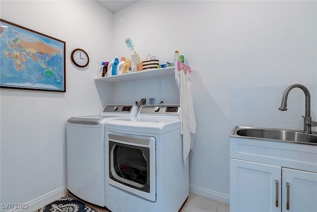 2114 Cold Canyon Ave, North Las Vegas, NV 89086 - washroom with independent washer and dryer, baseboards, a sink, cabinet space, and light tile patterned floors