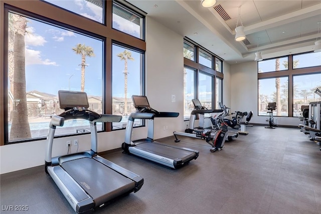2114 Cold Canyon Ave, North Las Vegas, NV 89086 - exercise room featuring a tray ceiling, baseboards, visible vents, and a high ceiling