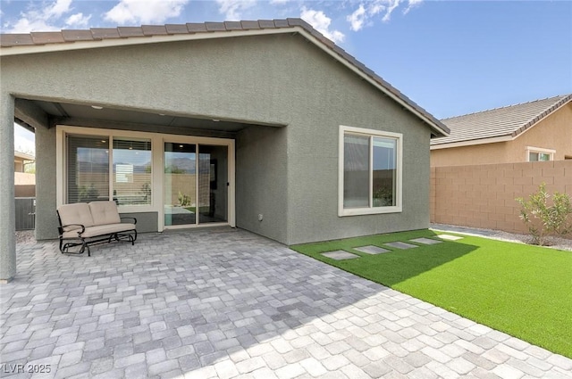2114 Cold Canyon Ave, North Las Vegas, NV 89086 - back of property with a yard, stucco siding, fence, and a patio area