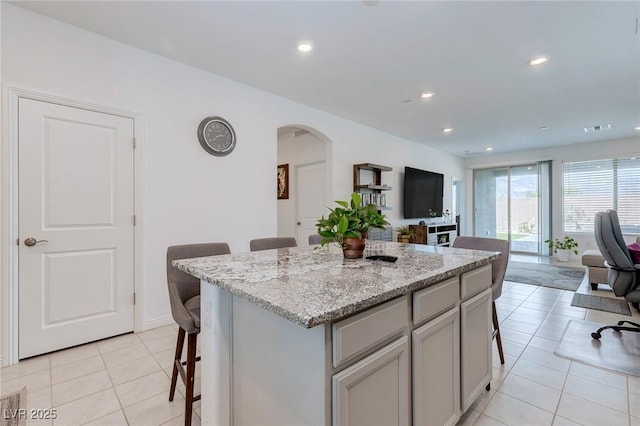 2114 Cold Canyon Ave, North Las Vegas, NV 89086 - kitchen with open floor plan, arched walkways, and a kitchen breakfast bar