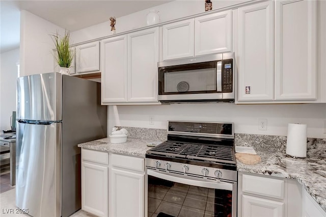 2114 Cold Canyon Ave, North Las Vegas, NV 89086 - kitchen featuring white cabinets, light stone counters, and appliances with stainless steel finishes