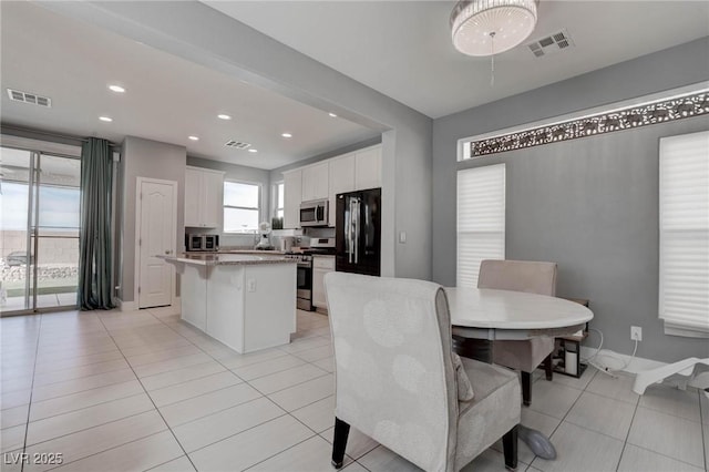 dining room featuring visible vents, recessed lighting, and light tile patterned floors