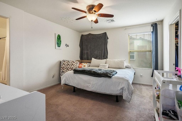 carpeted bedroom featuring baseboards, visible vents, and a ceiling fan