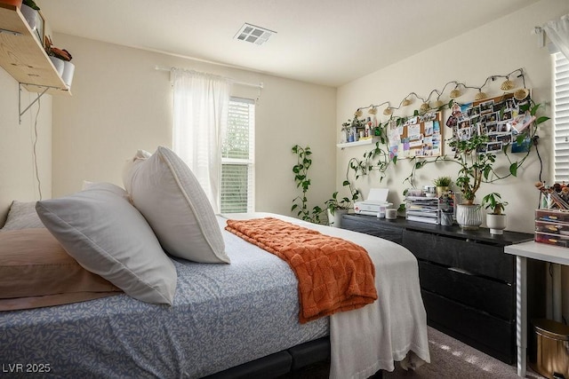 bedroom featuring carpet flooring and visible vents