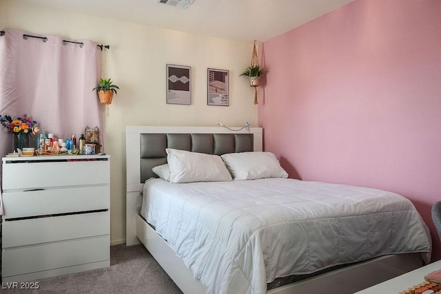 carpeted bedroom featuring visible vents