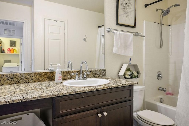 bathroom featuring toilet, shower / bath combo with shower curtain, and vanity
