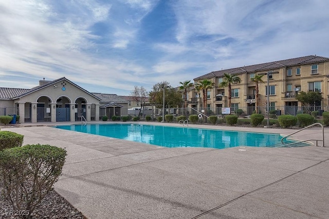 community pool featuring a patio area and fence