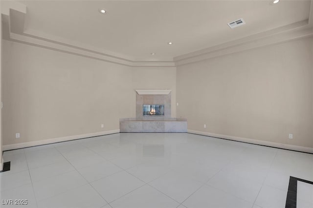 2290 Casa Bella Ct, Las Vegas, NV 89117 - unfurnished living room with a premium fireplace, a raised ceiling, recessed lighting, and tile patterned floors