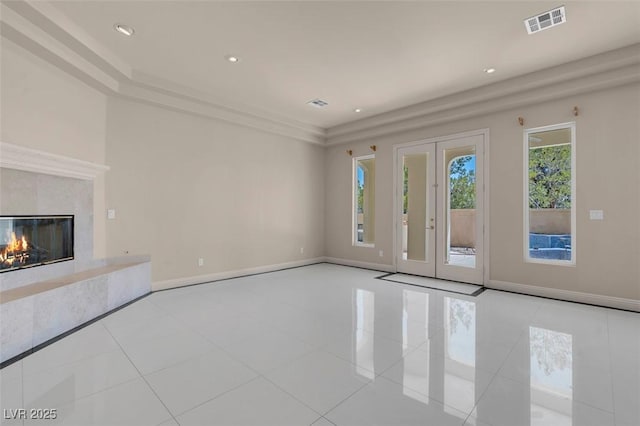 2290 Casa Bella Ct, Las Vegas, NV 89117 - unfurnished living room with tile patterned floors, recessed lighting, a high end fireplace, and french doors