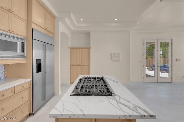 2290 Casa Bella Ct, Las Vegas, NV 89117 - kitchen featuring built in appliances, light brown cabinetry, french doors, a center island, and recessed lighting
