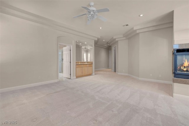 2290 Casa Bella Ct, Las Vegas, NV 89117 - unfurnished living room with light colored carpet, a ceiling fan, recessed lighting, and a multi sided fireplace