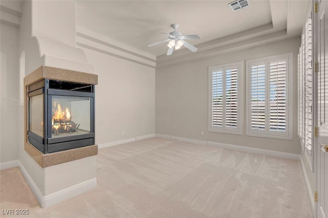 2290 Casa Bella Ct, Las Vegas, NV 89117 - unfurnished living room with a tray ceiling, carpet, and a ceiling fan