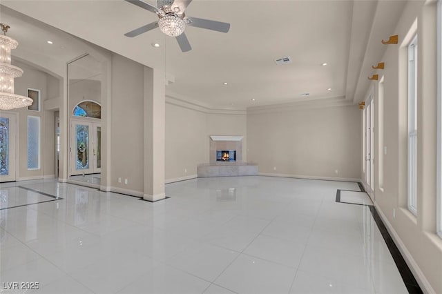 2290 Casa Bella Ct, Las Vegas, NV 89117 - unfurnished living room featuring tile patterned flooring, a chandelier, recessed lighting, a premium fireplace, and ornamental molding