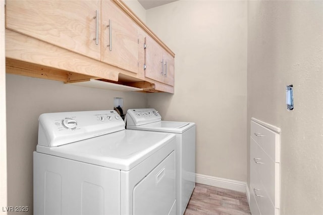 2290 Casa Bella Ct, Las Vegas, NV 89117 - laundry room with cabinet space, washing machine and clothes dryer, and light wood-style floors
