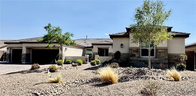 9511 Star Vista Ct, Las Vegas, NV 89149 - prairie-style home featuring stone siding, stucco siding, a garage, driveway, and a tiled roof
