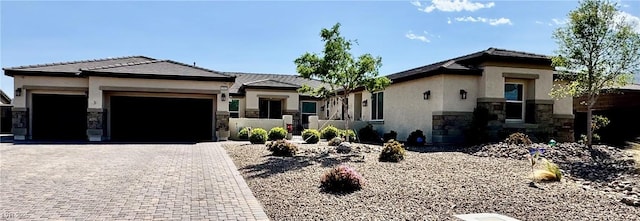 9511 Star Vista Ct, Las Vegas, NV 89149 - prairie-style home featuring a garage, stone siding, decorative driveway, and stucco siding