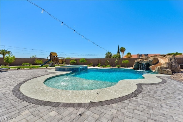 9511 Star Vista Ct, Las Vegas, NV 89149 - view of swimming pool featuring a fenced backyard, a patio area, a pool with connected hot tub, and a playground