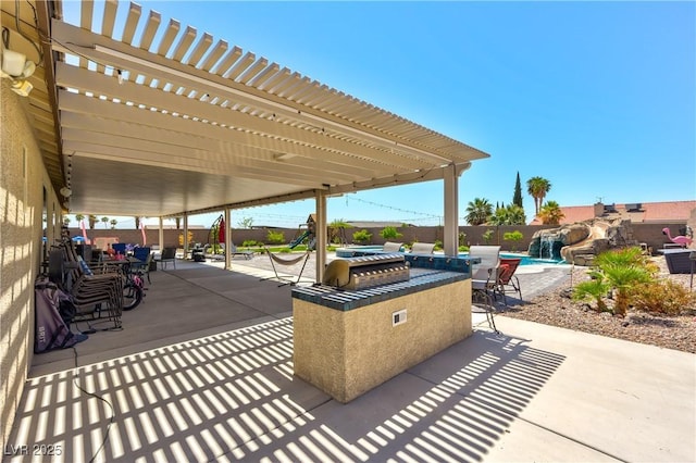 9511 Star Vista Ct, Las Vegas, NV 89149 - view of patio featuring a fenced backyard, a pergola, and an outdoor kitchen