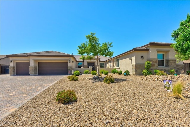 9511 Star Vista Ct, Las Vegas, NV 89149 - view of front facade with stone siding, stucco siding, an attached garage, decorative driveway, and a tile roof