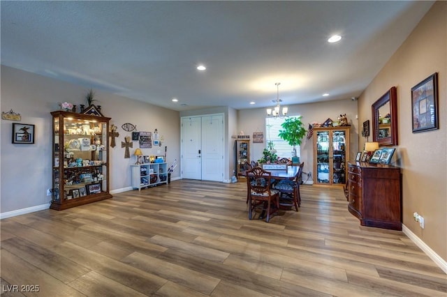 9511 Star Vista Ct, Las Vegas, NV 89149 - dining room featuring a chandelier, wood finished floors, recessed lighting, and baseboards